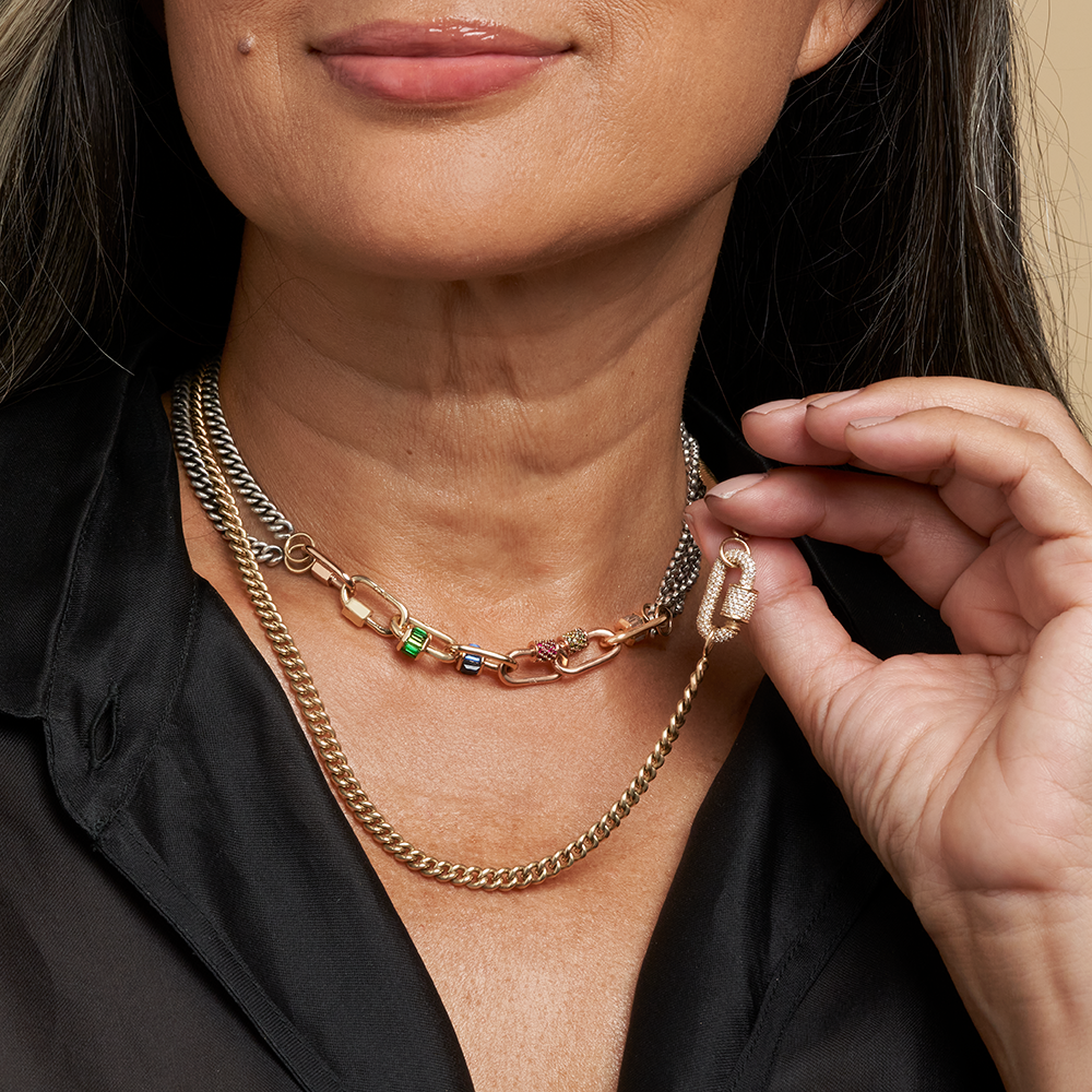 Close up of woman's decolletage wearing tsavorite jewelry lock