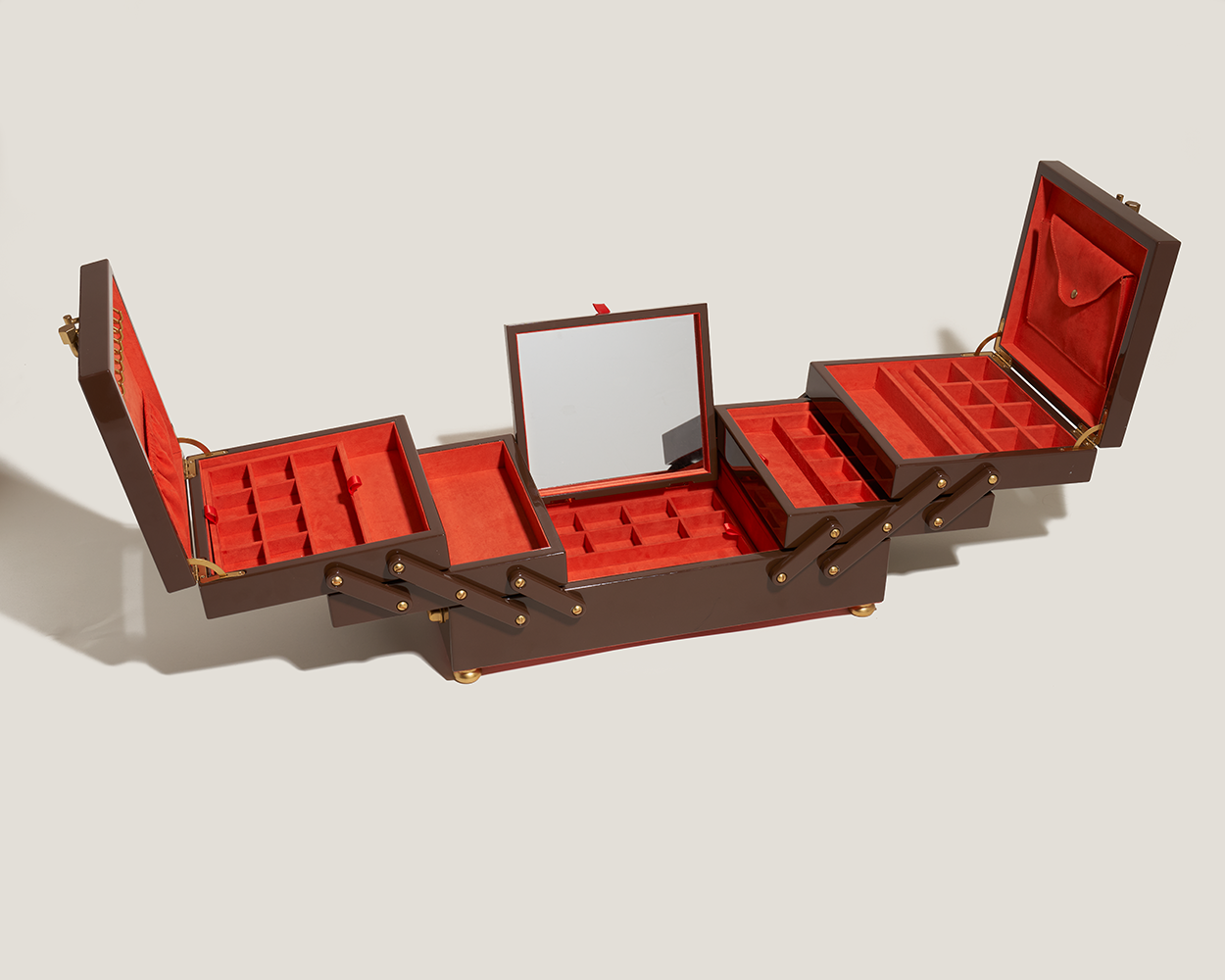 Open unique jewelry box with wooden exterior and red interior and attachment mirror