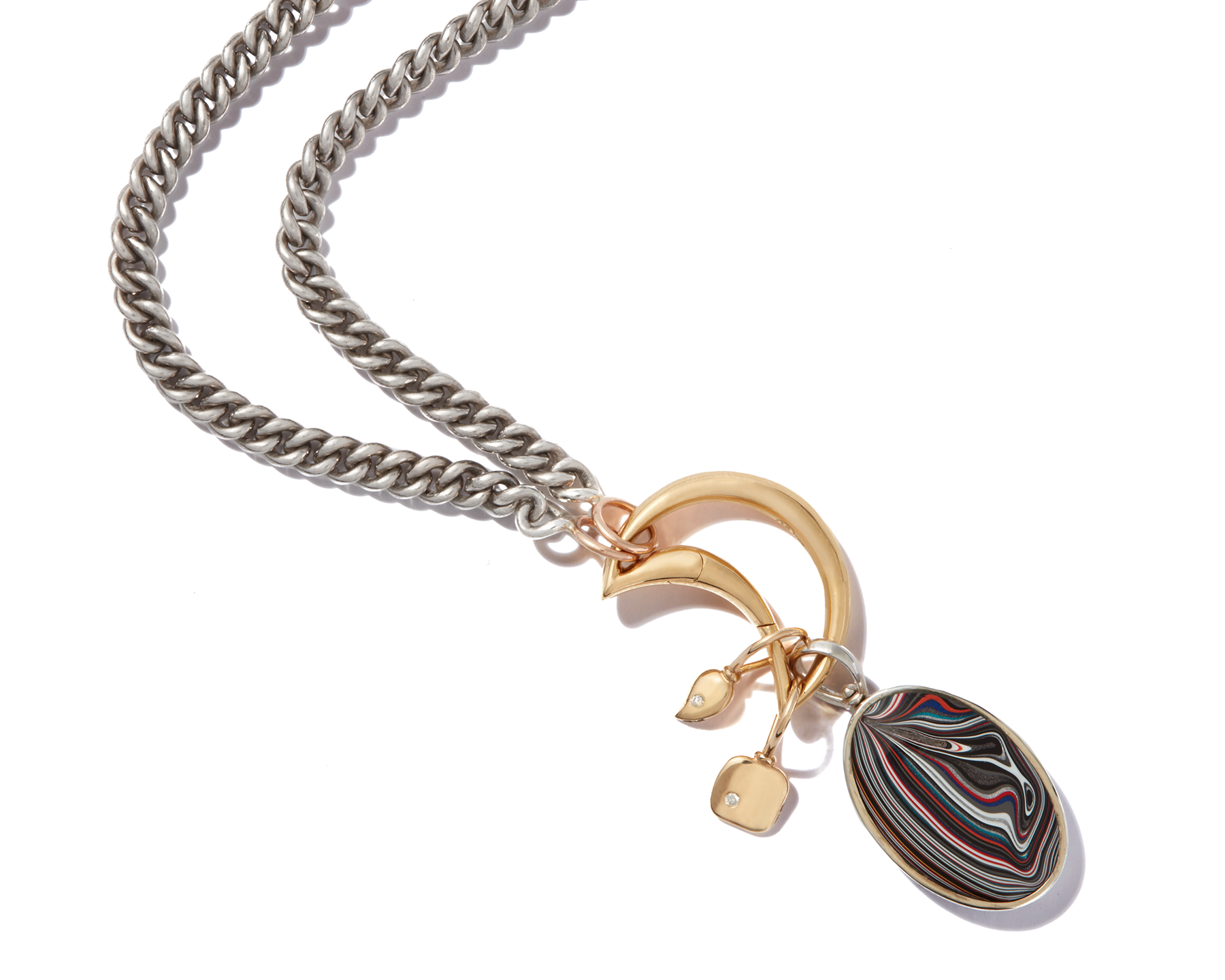 Close up of gold necklace with tiny gold charms and moon lock