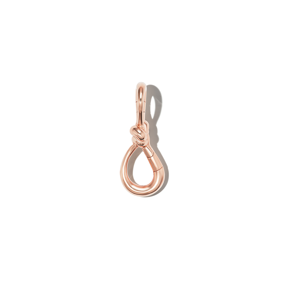 Front shot of rose gold knot lock against white backdrop