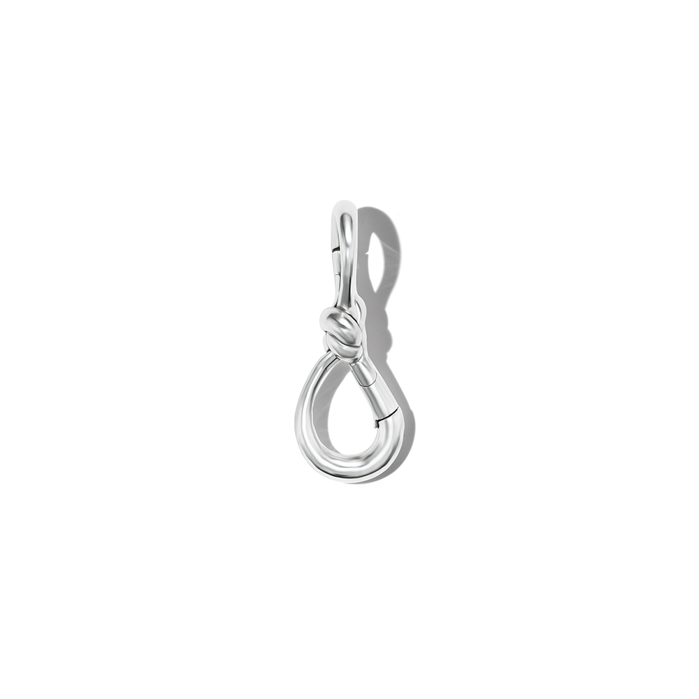Silver knot lock charm against white backdrop