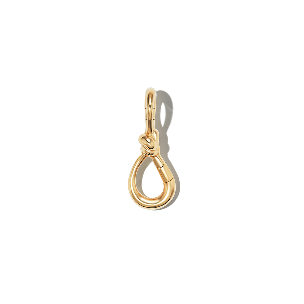 Front shot of gold knot lock against white backdrop