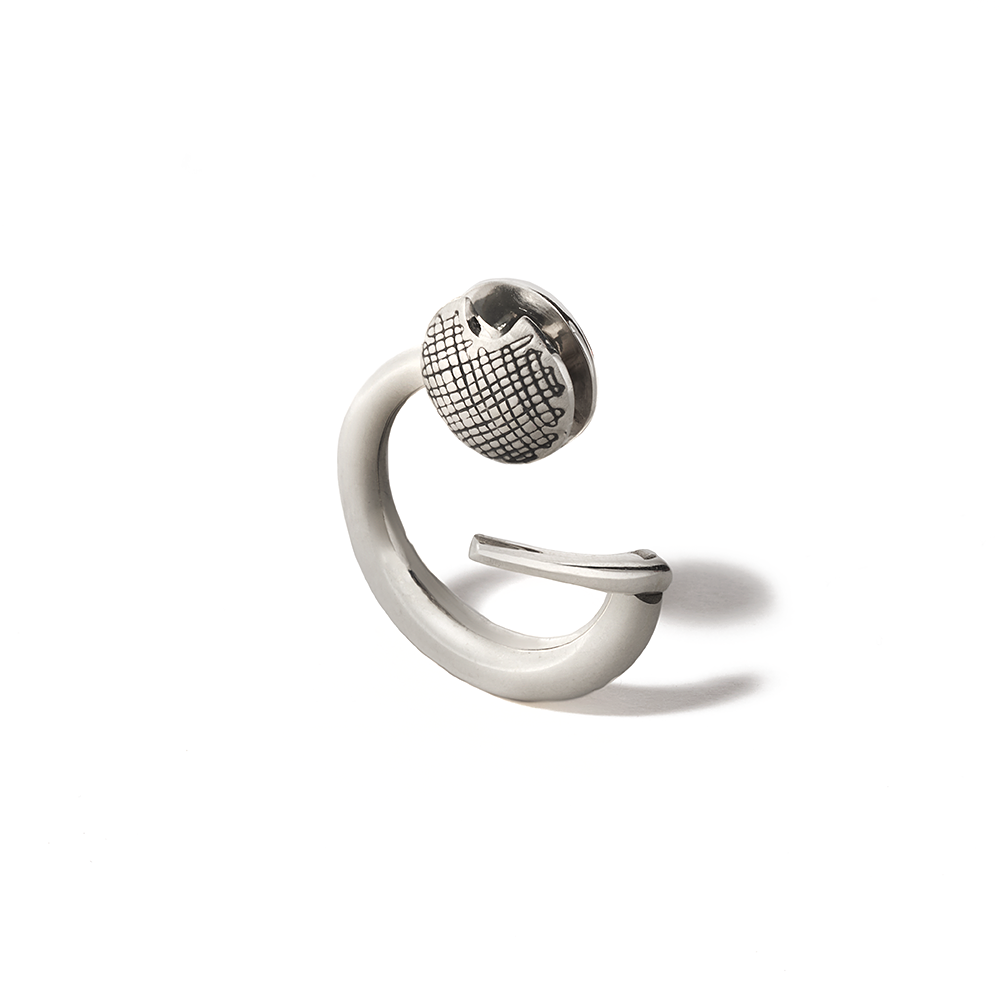 Angled front shot of silver disc charm with silver clasp against white backdrop