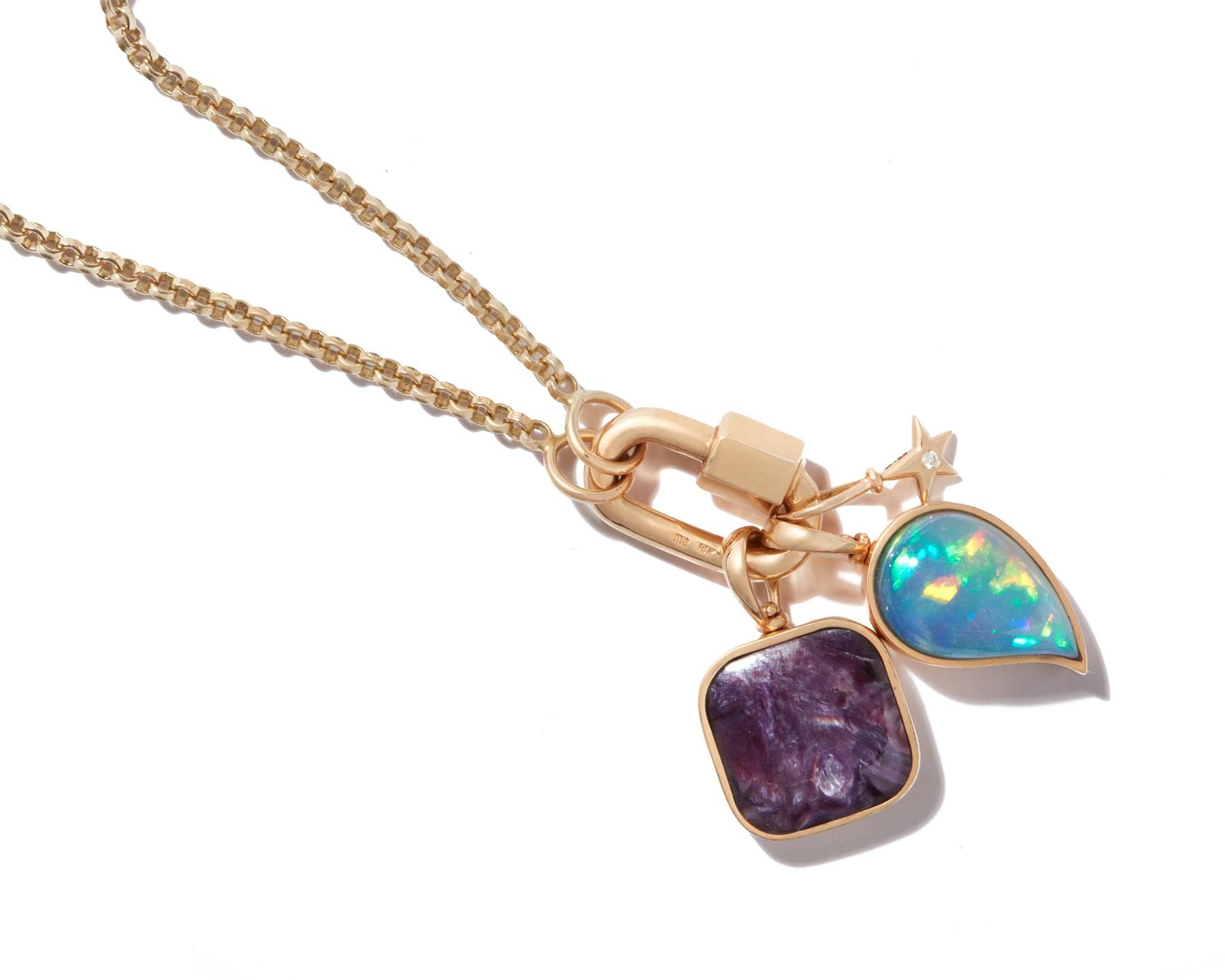 Close up of gold necklace with tiny gold necklace charm and gemstone charms