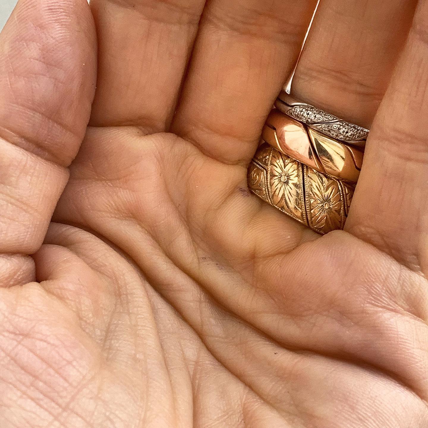 Close up of hand wearing hand engraved ring