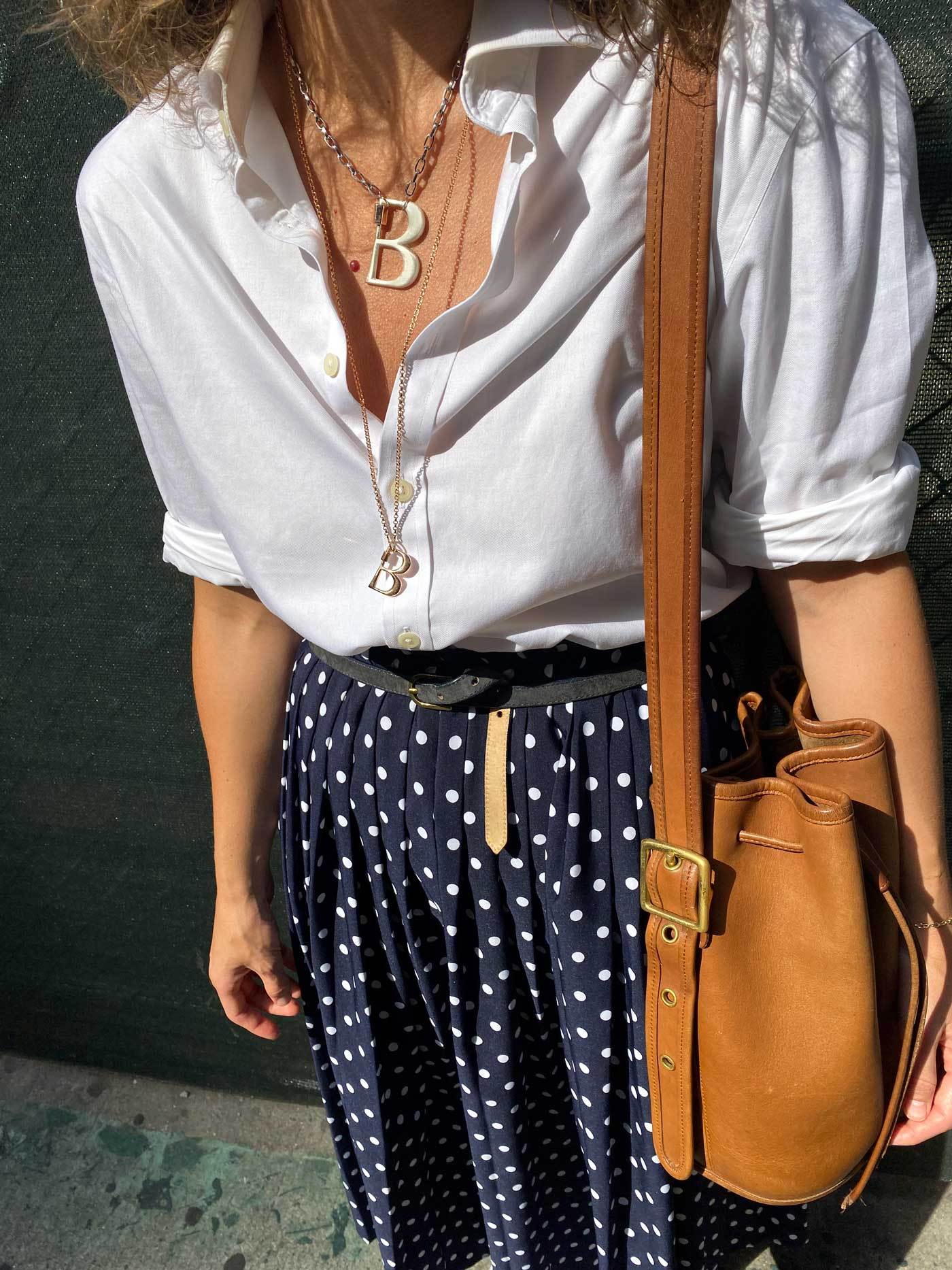 Woman wearing necklace with B lock
