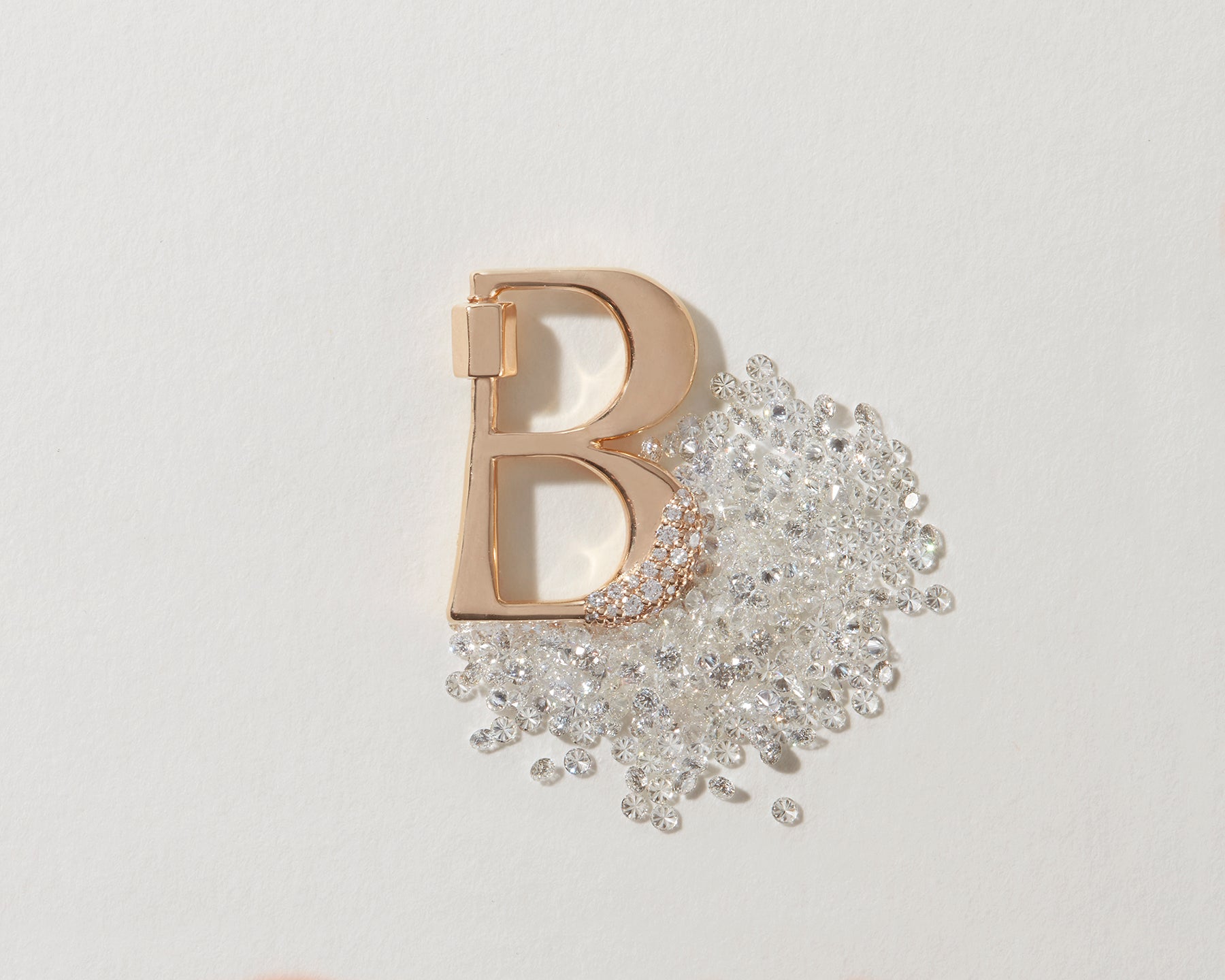 Gold B lock alongside pile of diamonds