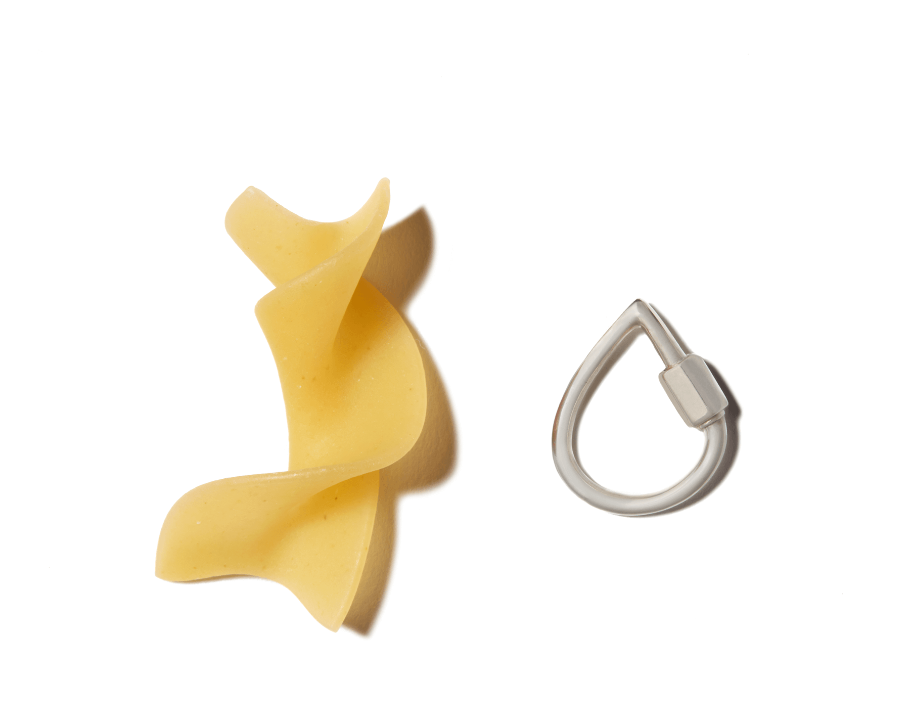 Small silver droplock alongside piece of pasta