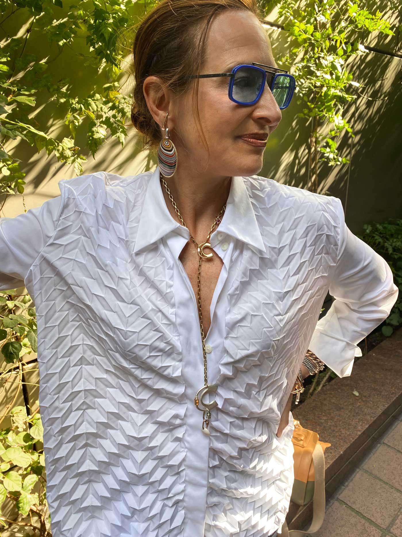 Woman wearing necklace with C lock
