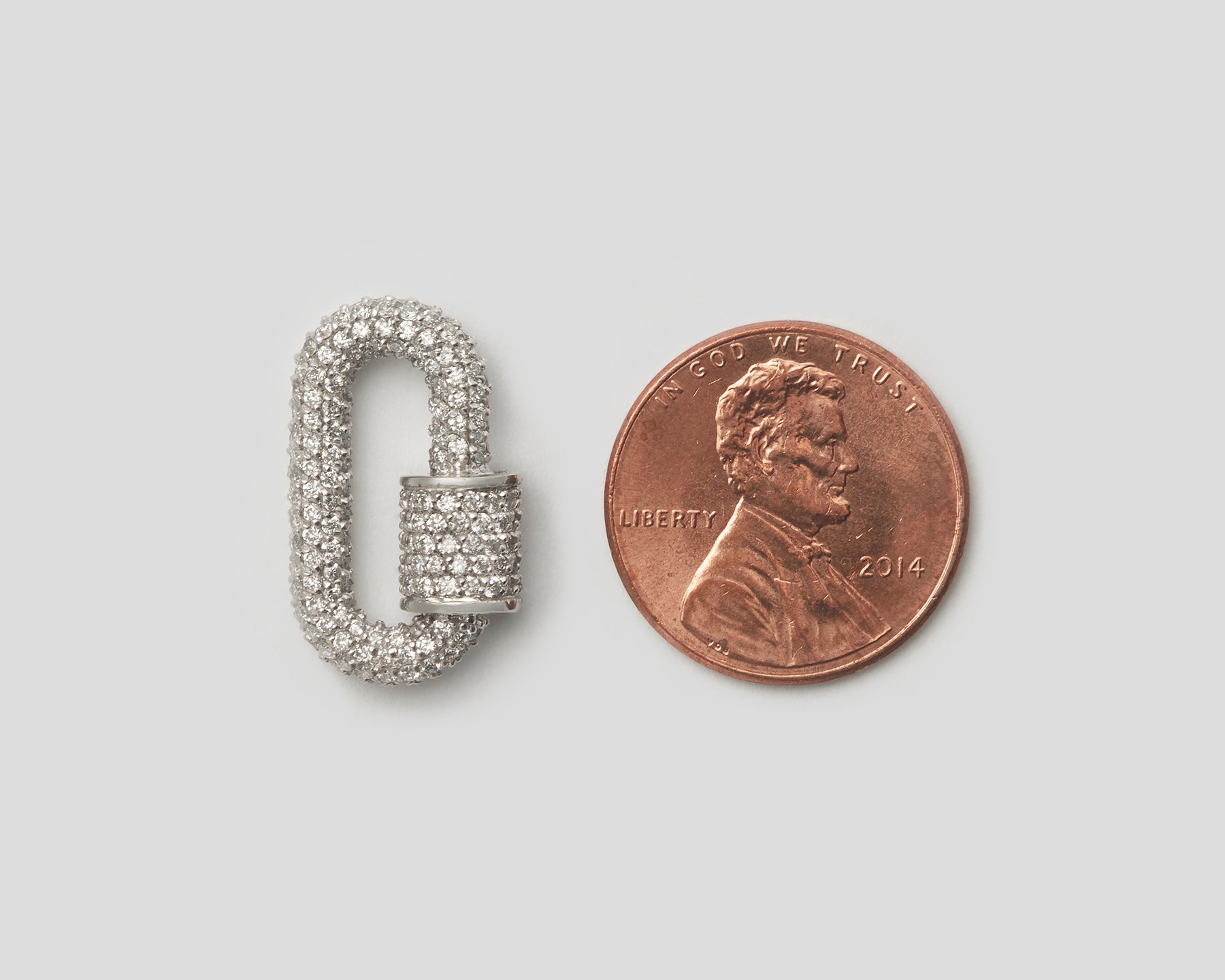 Silver diamond babylock alongside penny