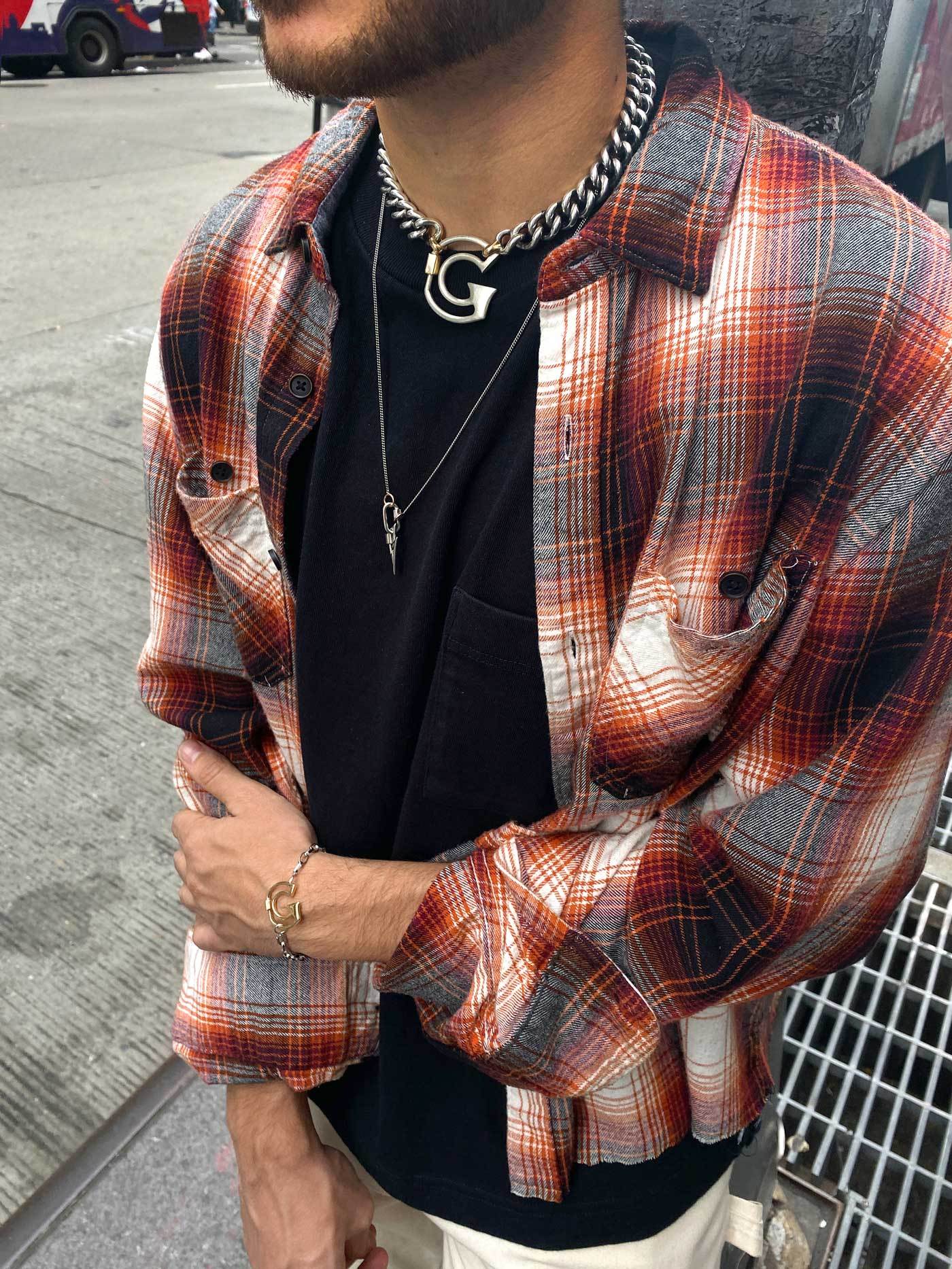 Man wearing necklace with G lock