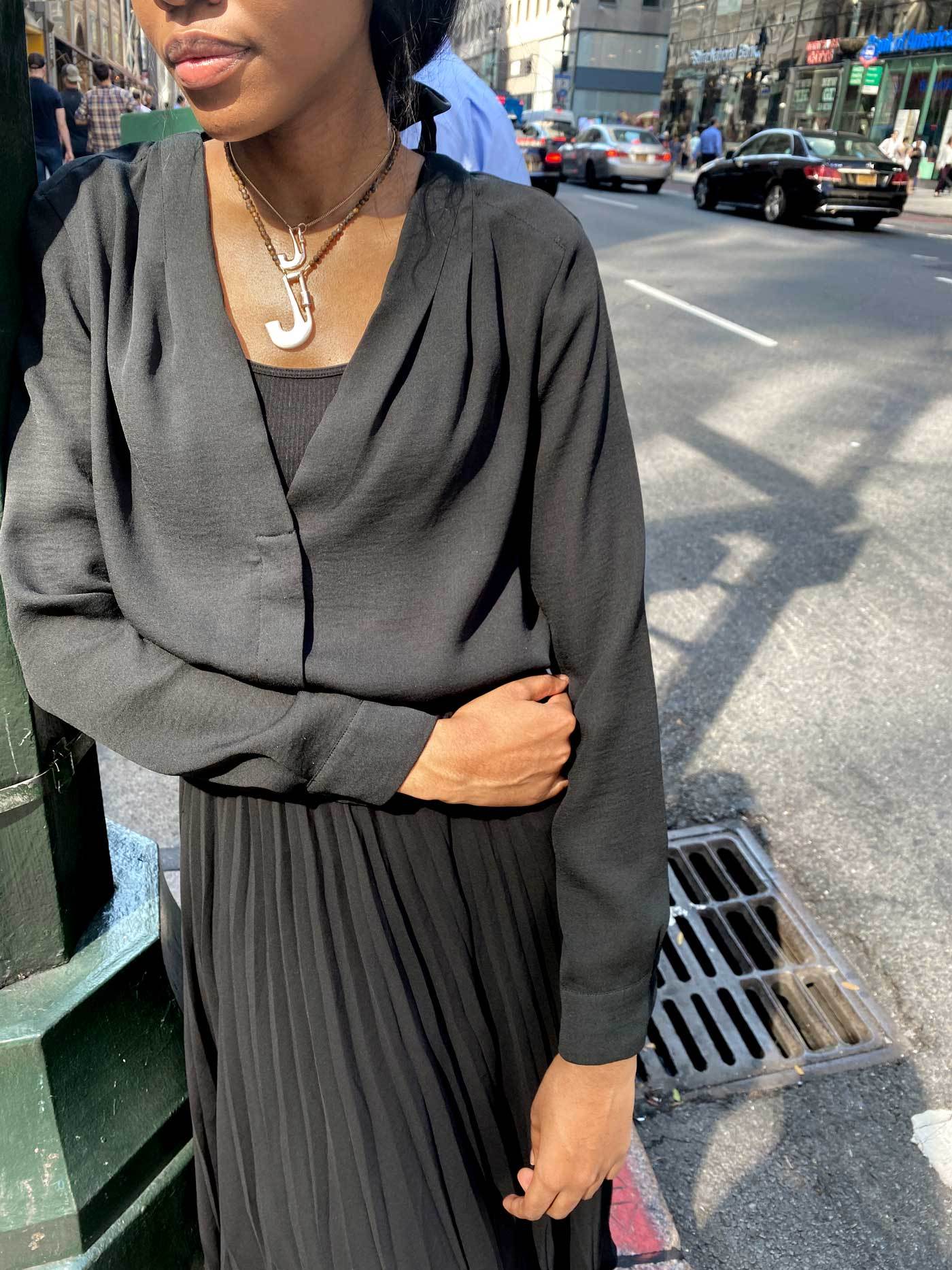 Woman wearing necklace with J lock