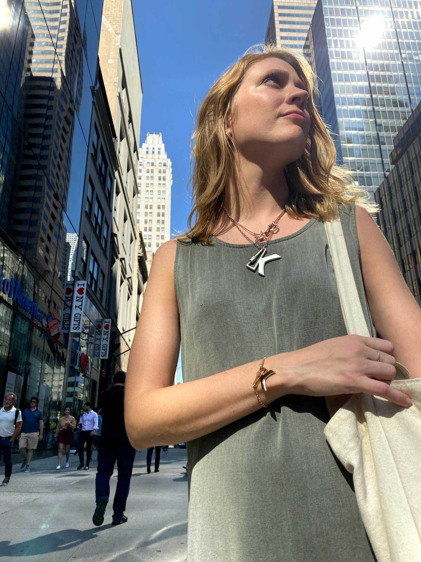 Woman wearing necklace with K lock