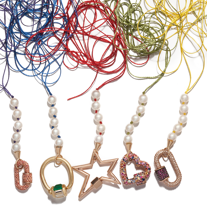 Colorful custom pearl necklace strands with stoned gold locks lined up next to each other