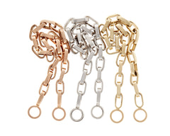 Rose gold biker chain, silver biker chain, and gold biker chain beside one another against white backdrop