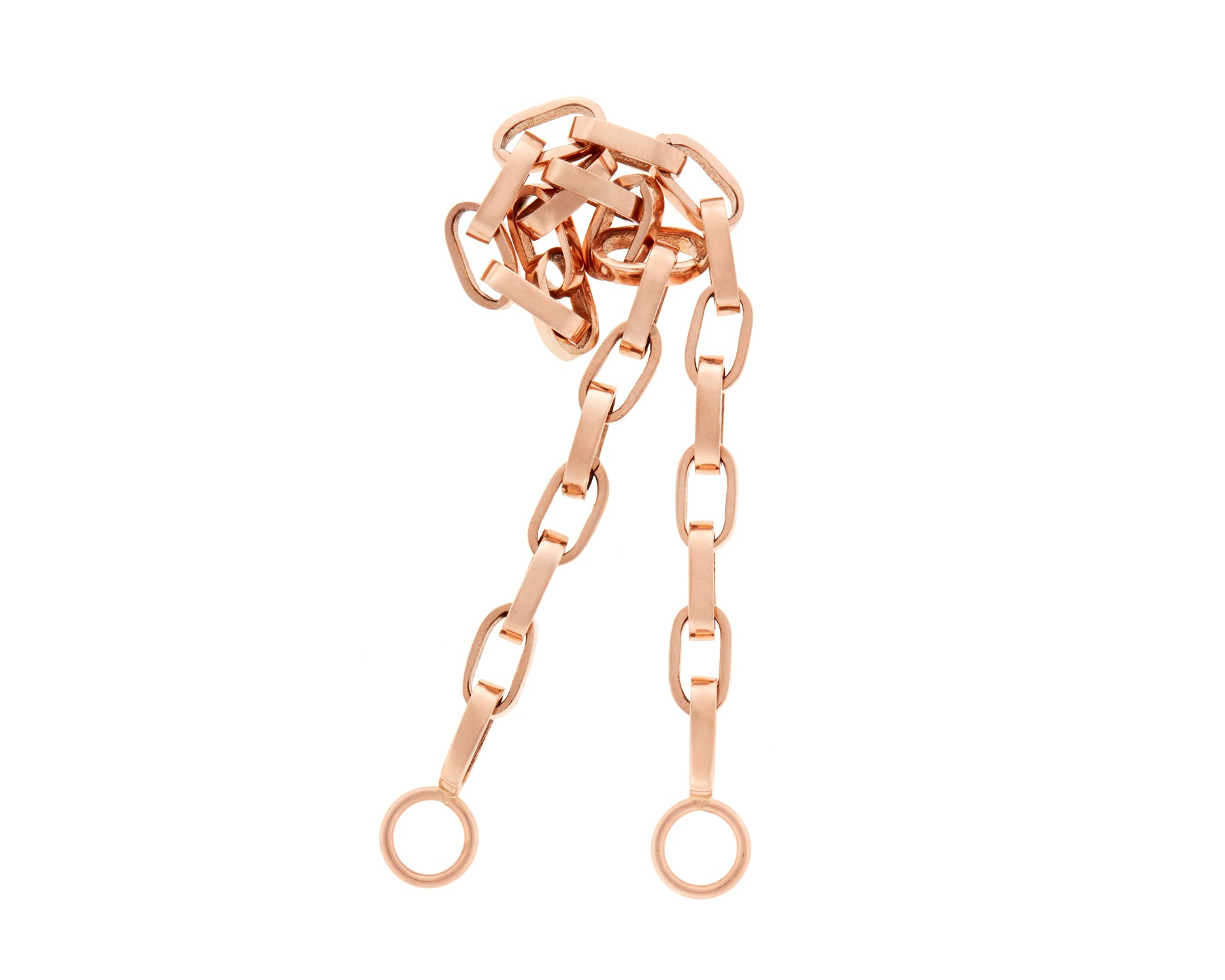 Curled up rose gold Marla Aaron biker chain against white backdrop