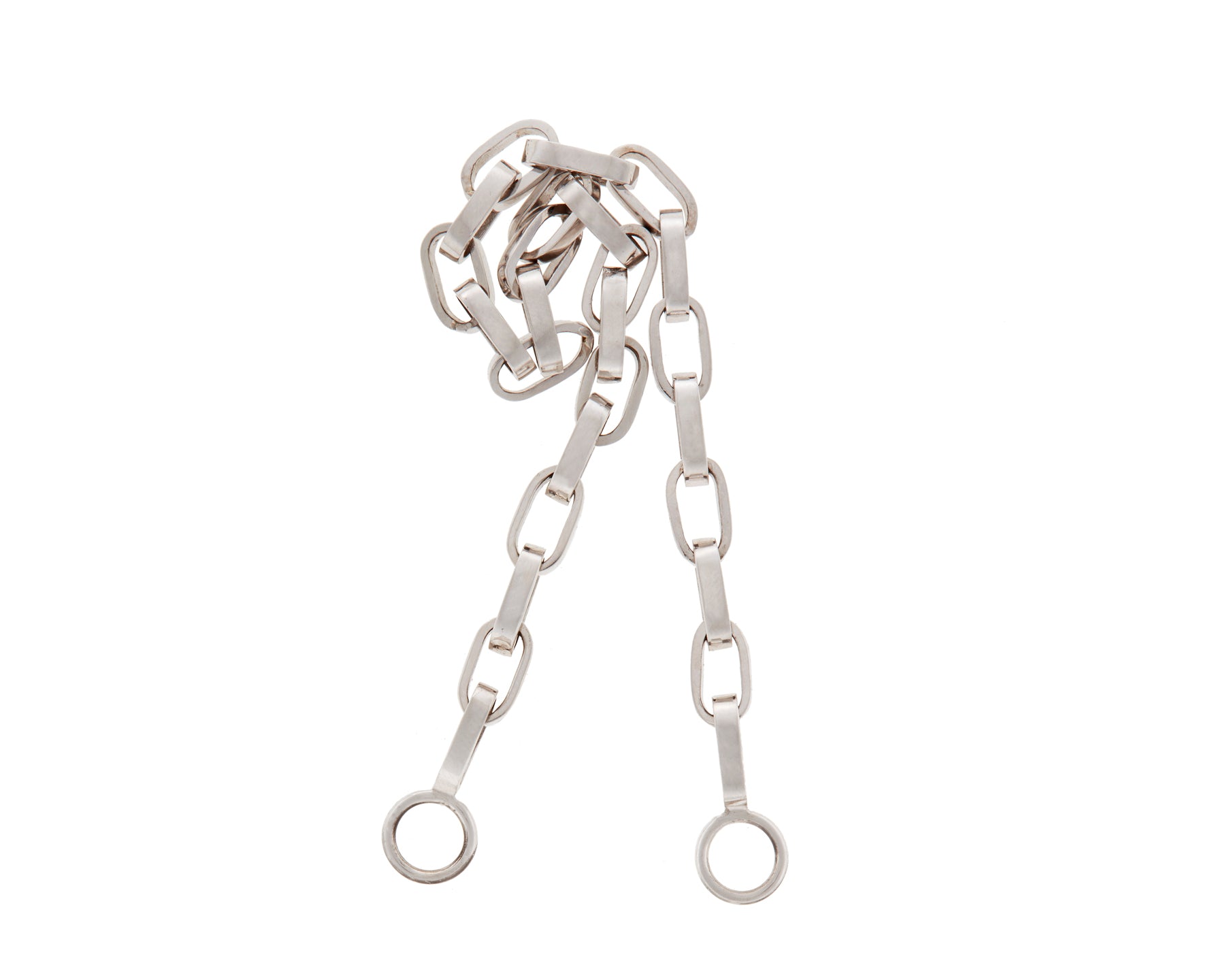 Curled up silver Marla Aaron biker chain against white backdrop