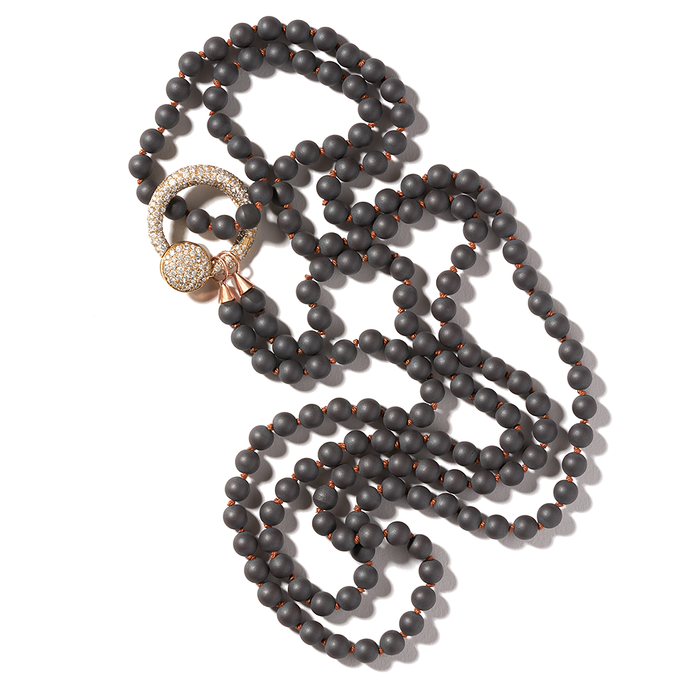 Curled up black bead necklace with diamond studded pendant