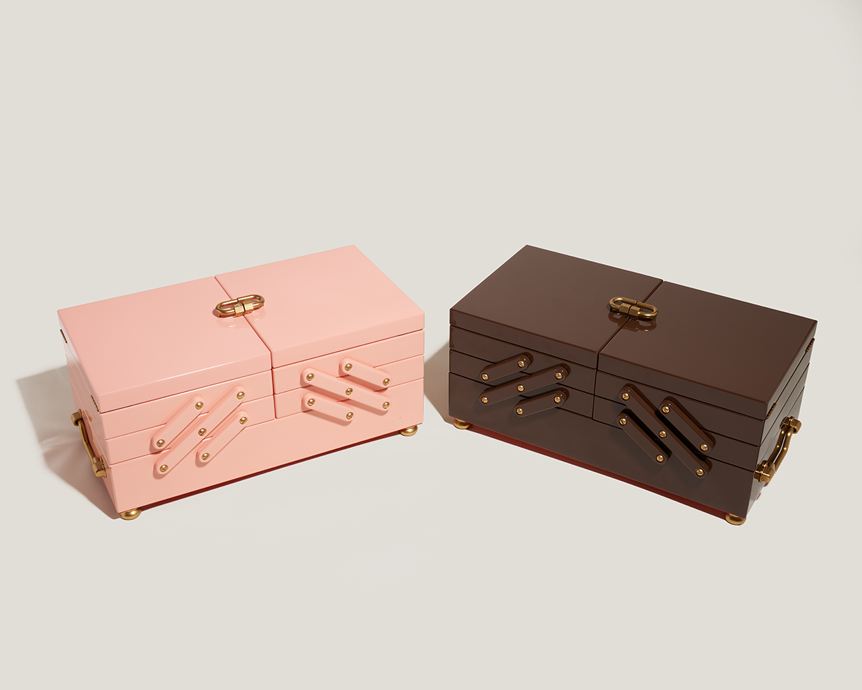 Pink jewelry box alongside wooden jewelry box