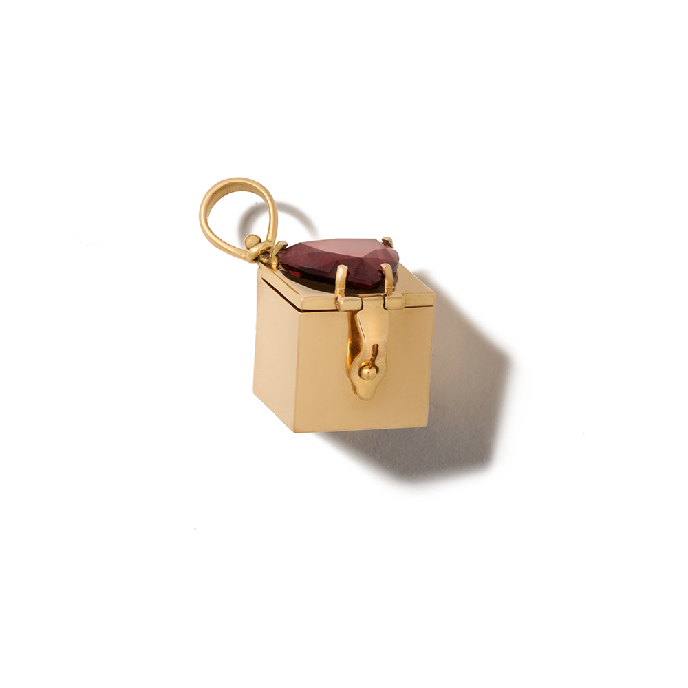 Angled front view of closed garnet box charm