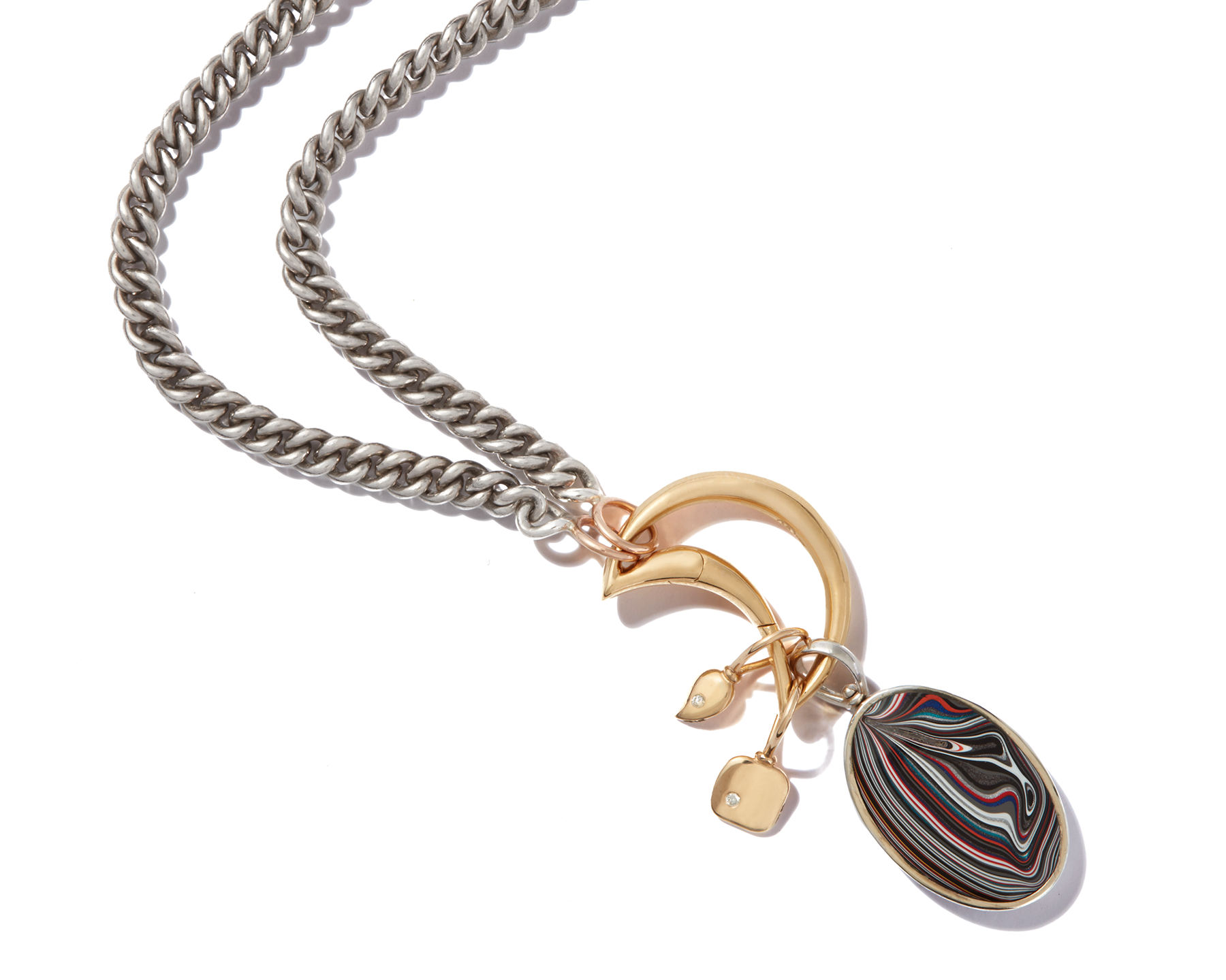 Close up of necklace with gold moon charm and fordite charm