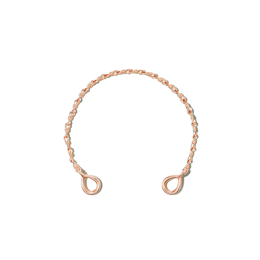 Rose gold knot bracelet chain against white backdrop
