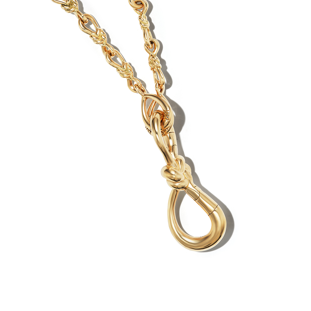 Close up of charm on lover's knot necklace gold