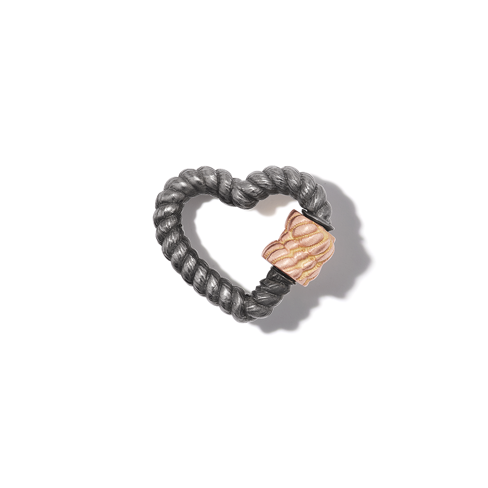 Blackened silver twist heart charm with rose gold clasp against white backdrop