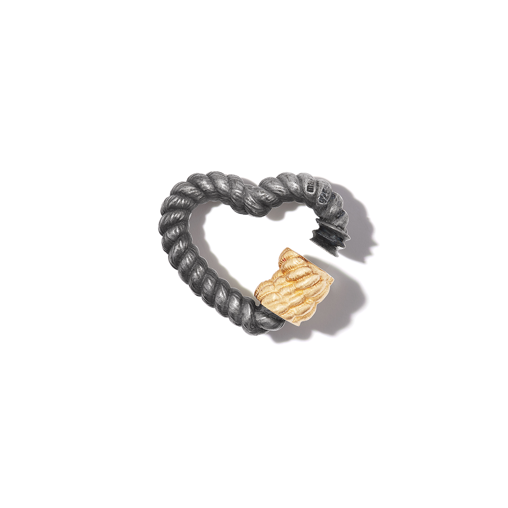 Blackened silver twisted heartlock charm with open yellow gold clasp against white backdrop