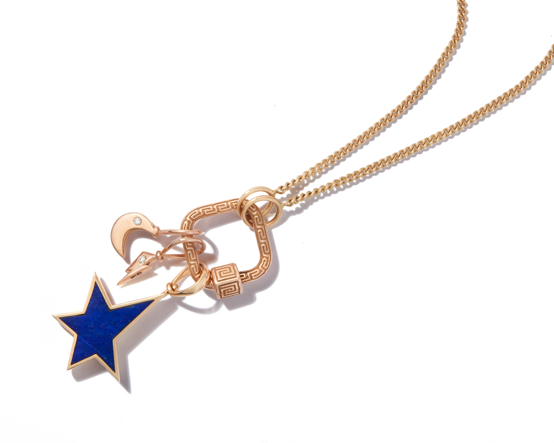 Close up of gold necklace with tiny gold charms for necklace and blue star charm