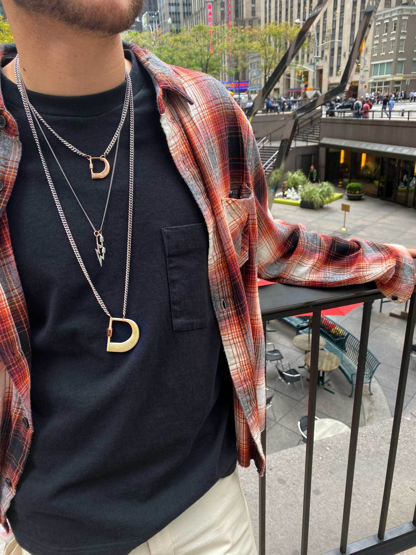 Man wearing necklace with D lock