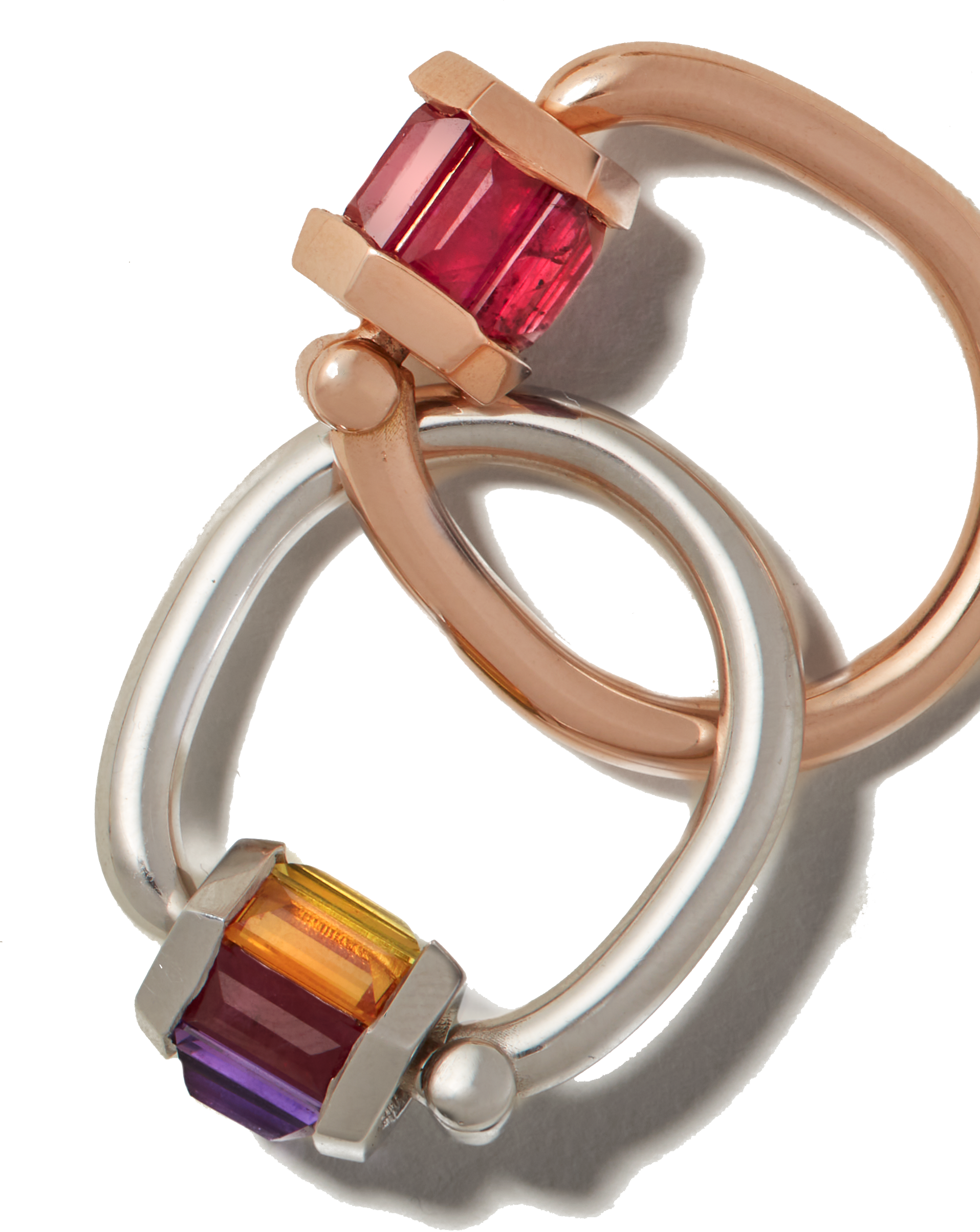 Rose gold ruby ring interlocked with silver rainbow gemstone ring