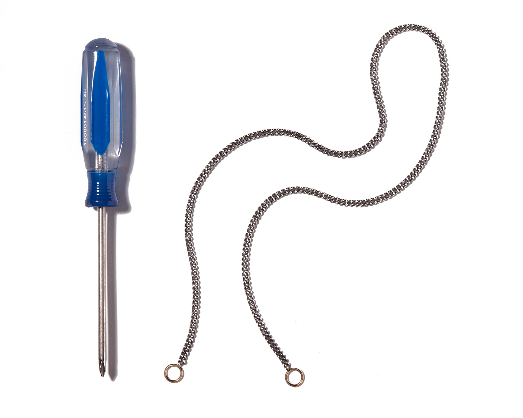Curb chain necklace alongside blue screwdriver
