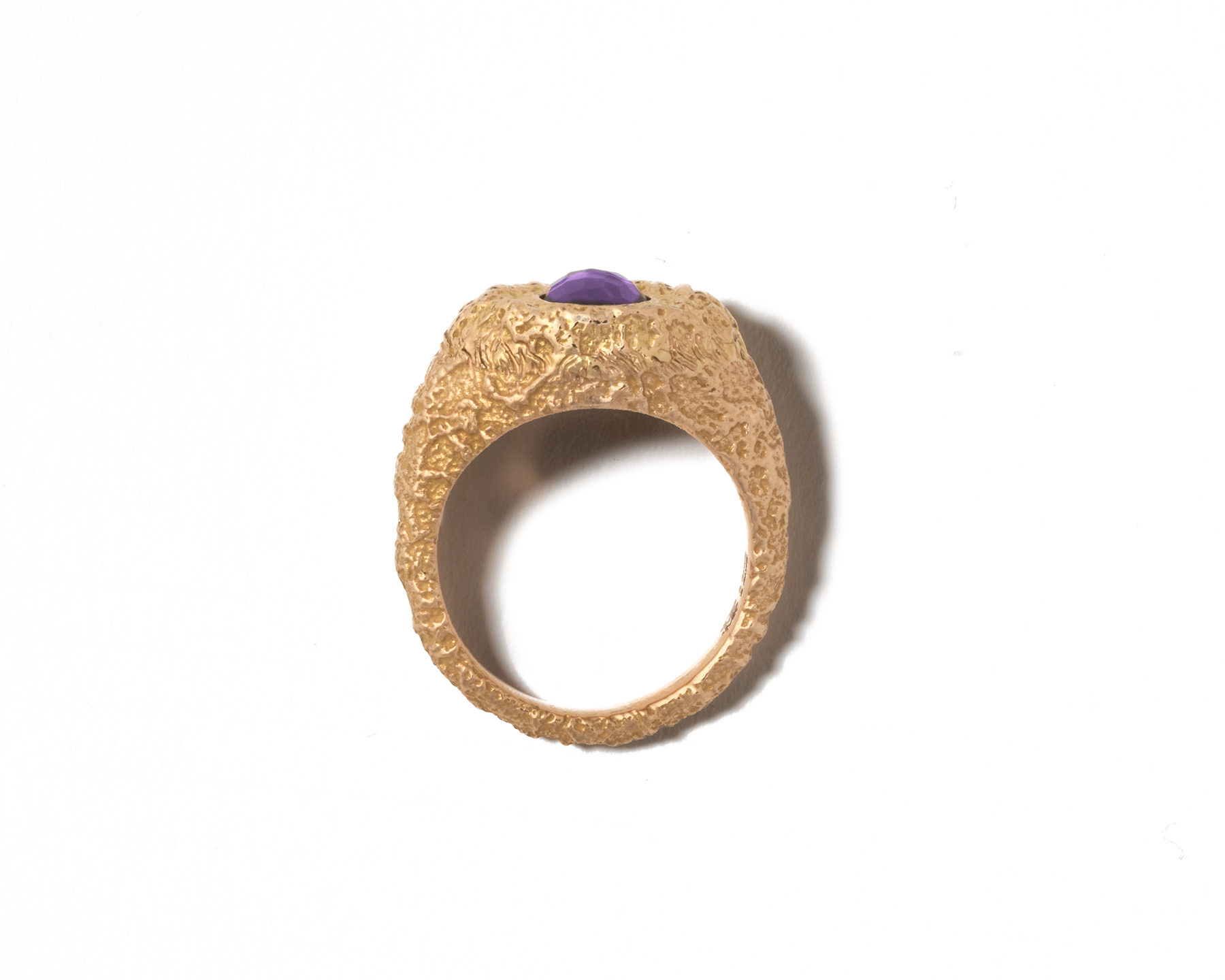 Front shot of gold amethyst ring against white backdrop