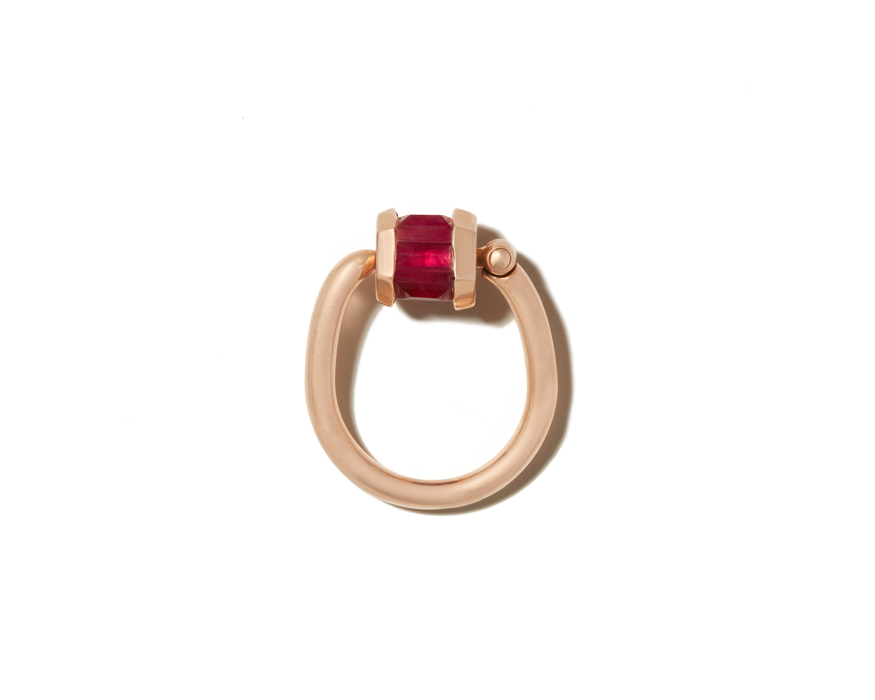 Rose gold ruby ring with open trundle lock against white backdrop