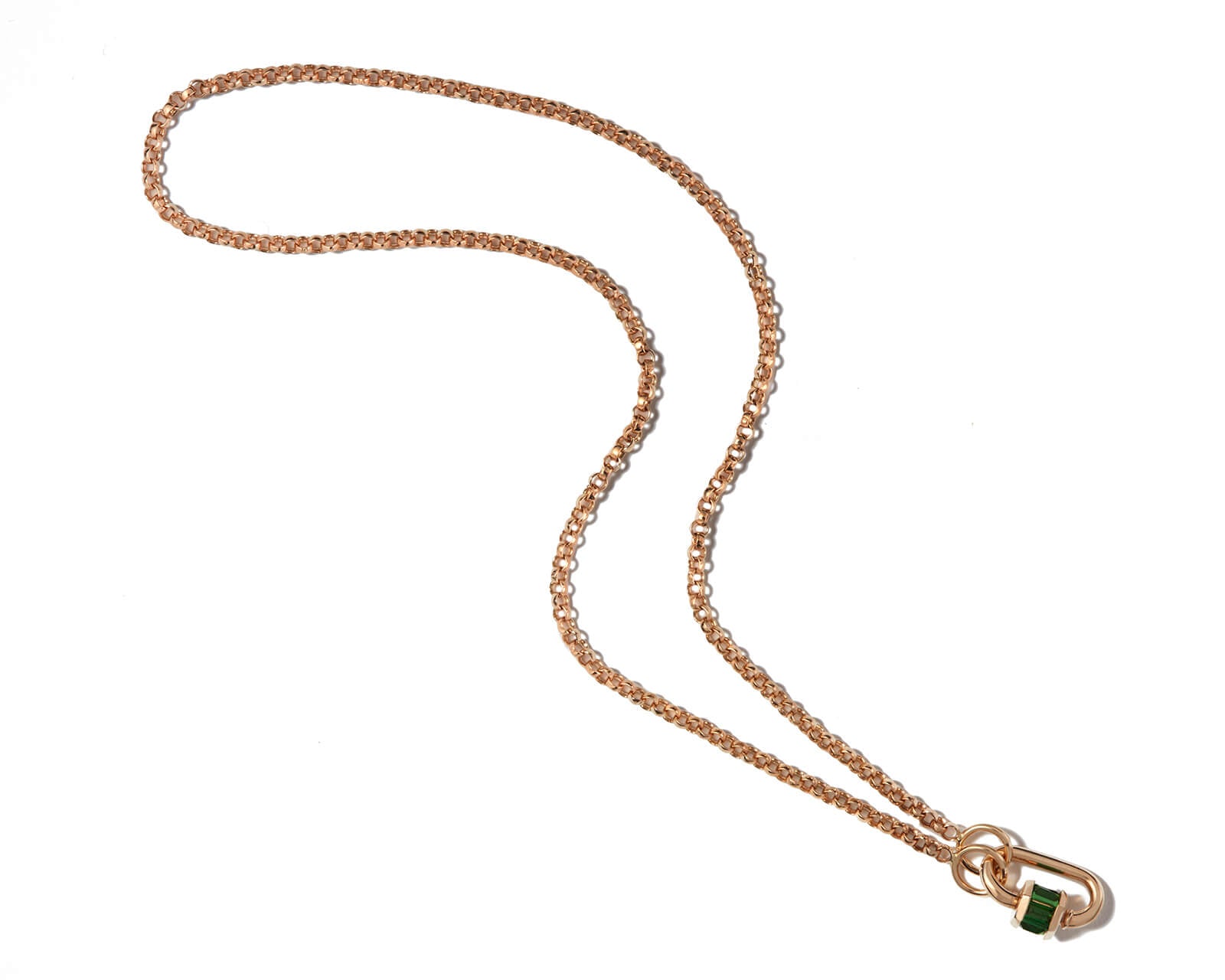 Green garnet charm attached to gold chain against white backdrop